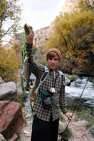 Student holding a fish they caught